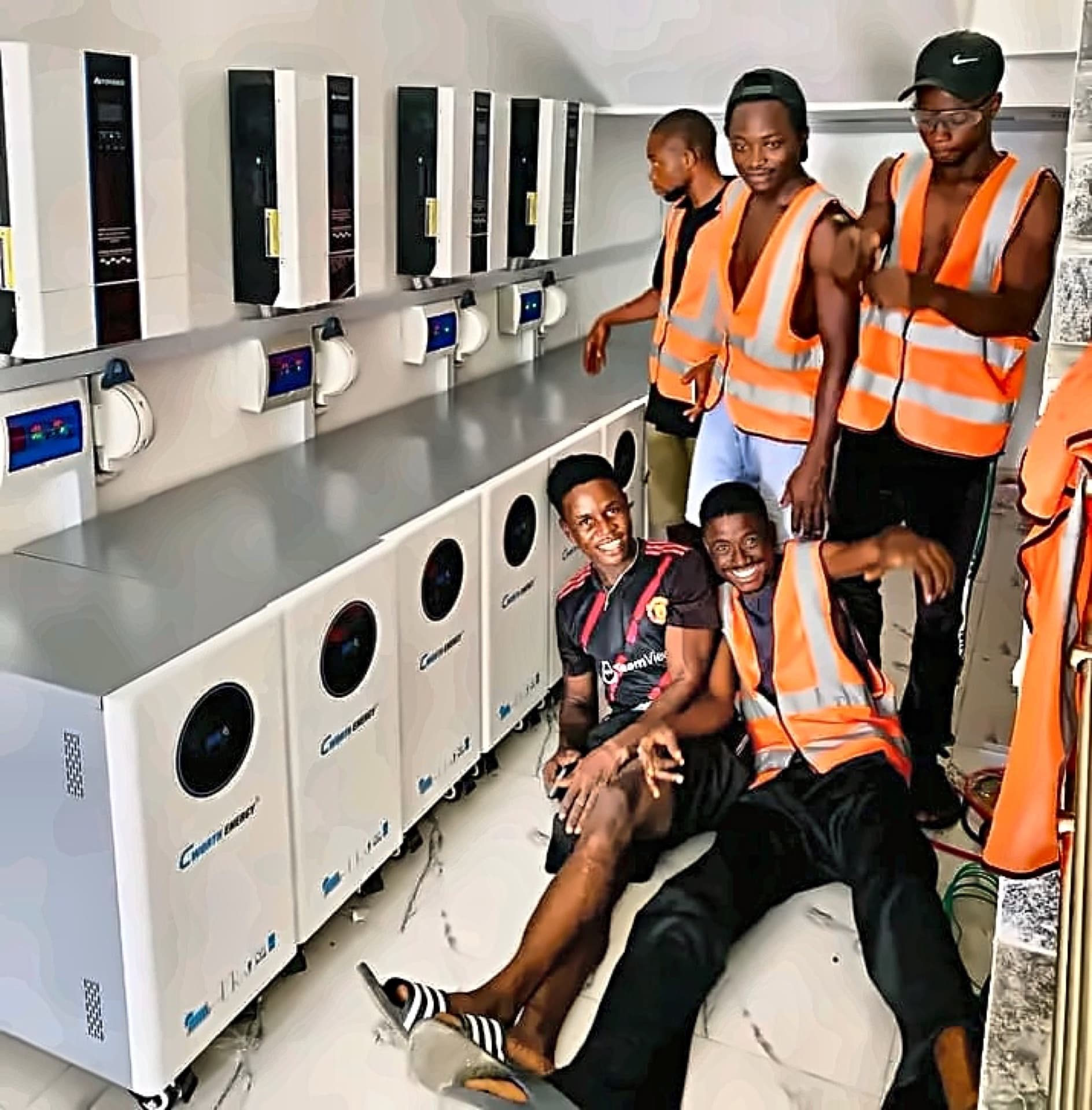 Suburban installation team in front of a completed inverter bank