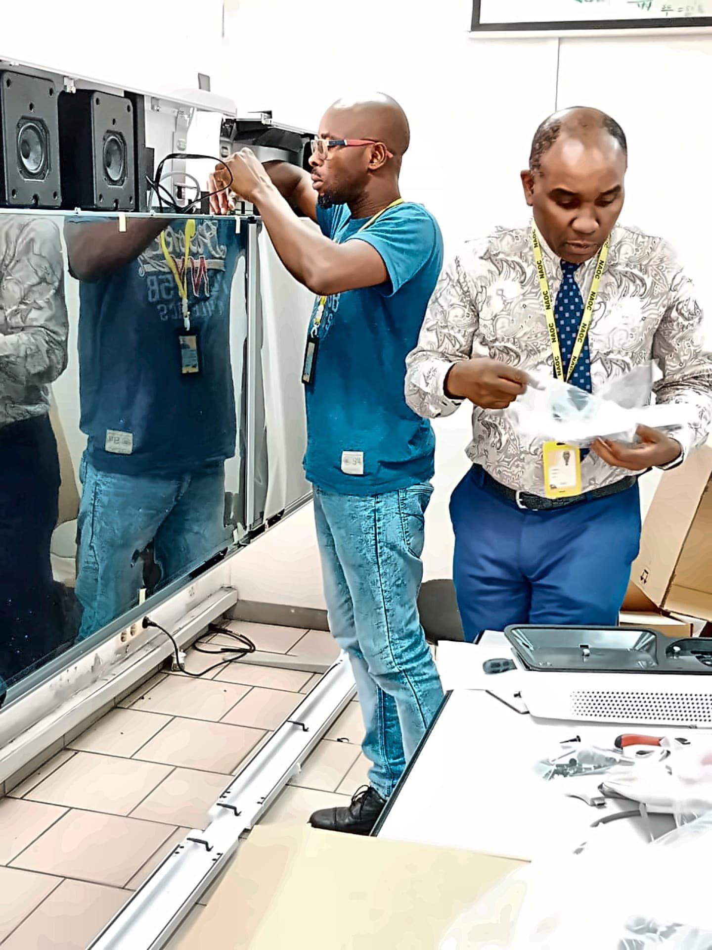 Technicians assembling audio-visual and electronic equipment on site