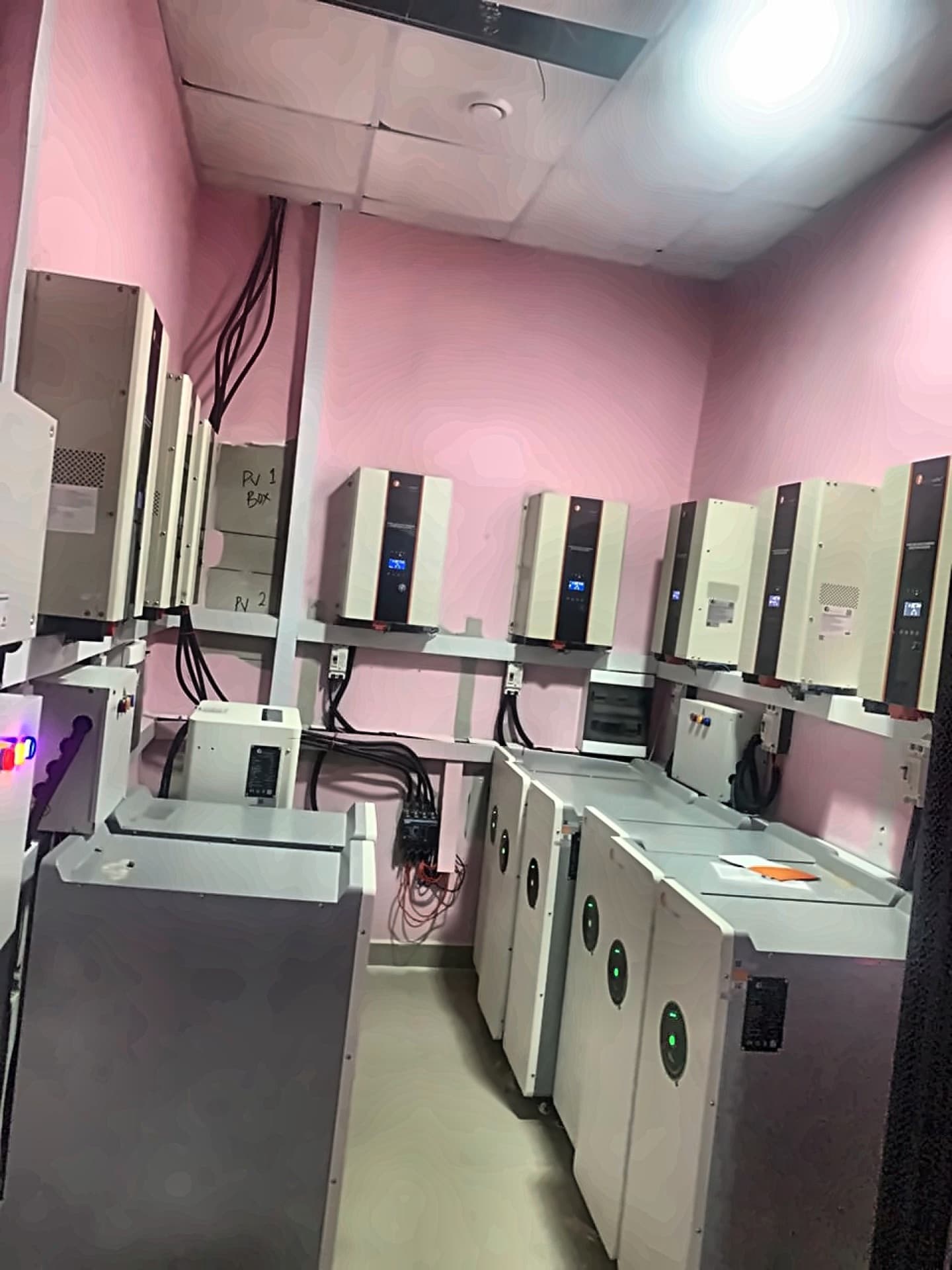 Inverter wall units with floor-standing battery cabinets during commissioning